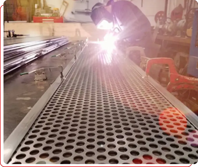 A person welding on a metal surface.