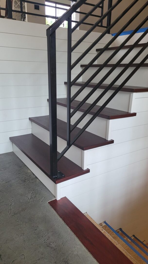 A staircase with wooden steps and metal railing.