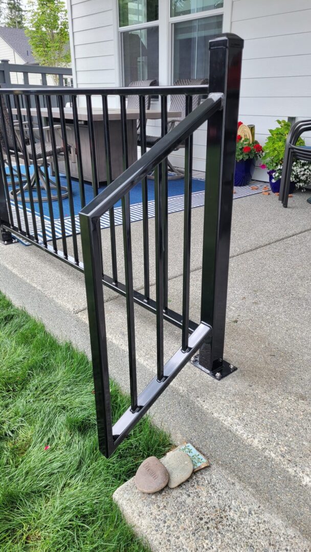 A black metal railing on the side of a house.