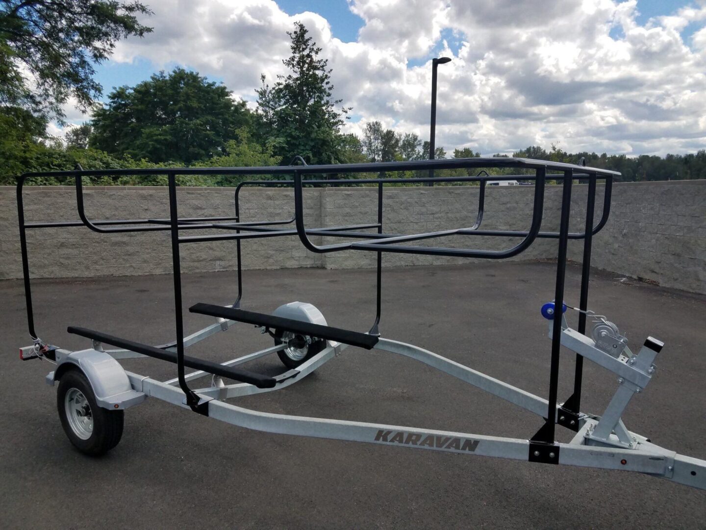 A boat trailer with two wheels and four bars.