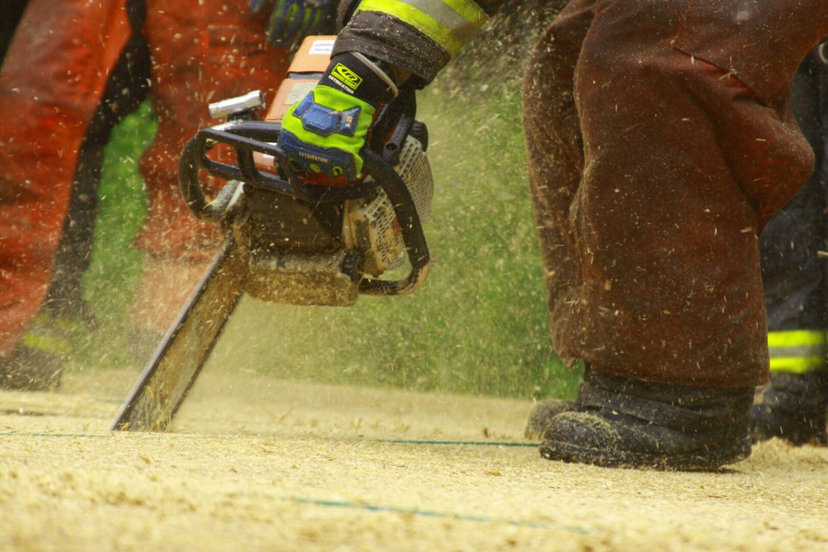 A person with a saw cutting wood