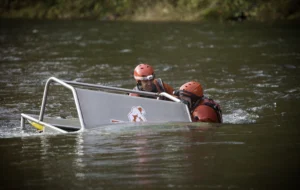 Two people in a boat on the water.