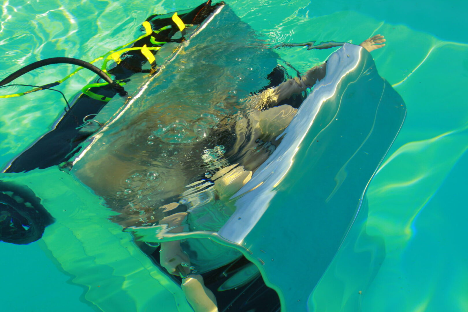 A man in the water with a metal object.