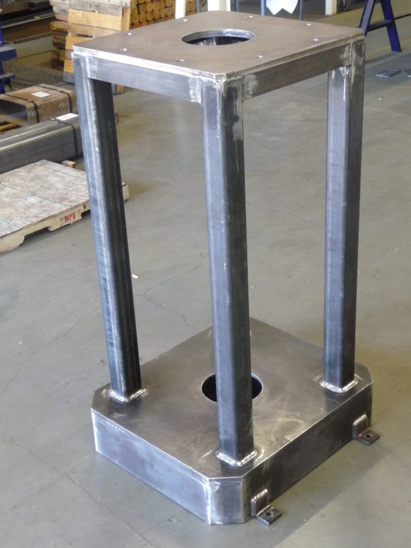 A metal stand with two legs and one leg in the middle.