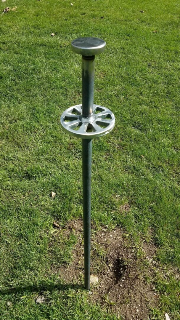 A pole with a metal ring on top of it.