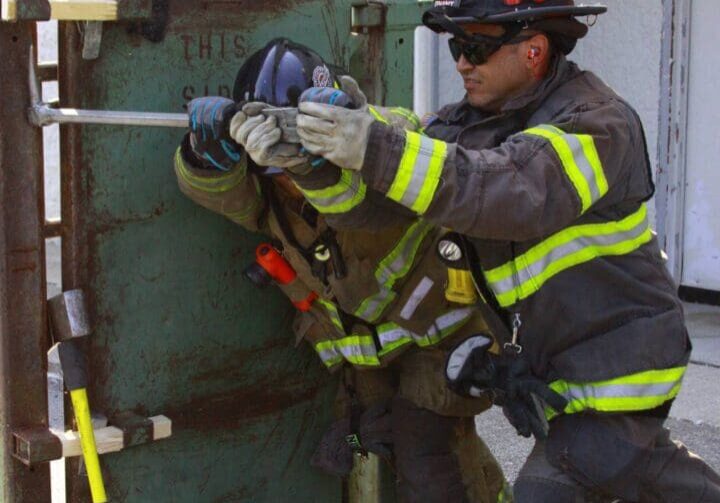 A fireman is using the hose to shut off the fire hydrant.