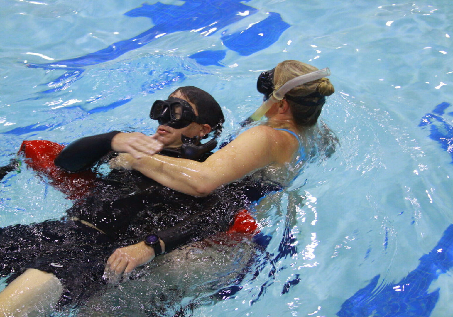 A woman in the water with another person.