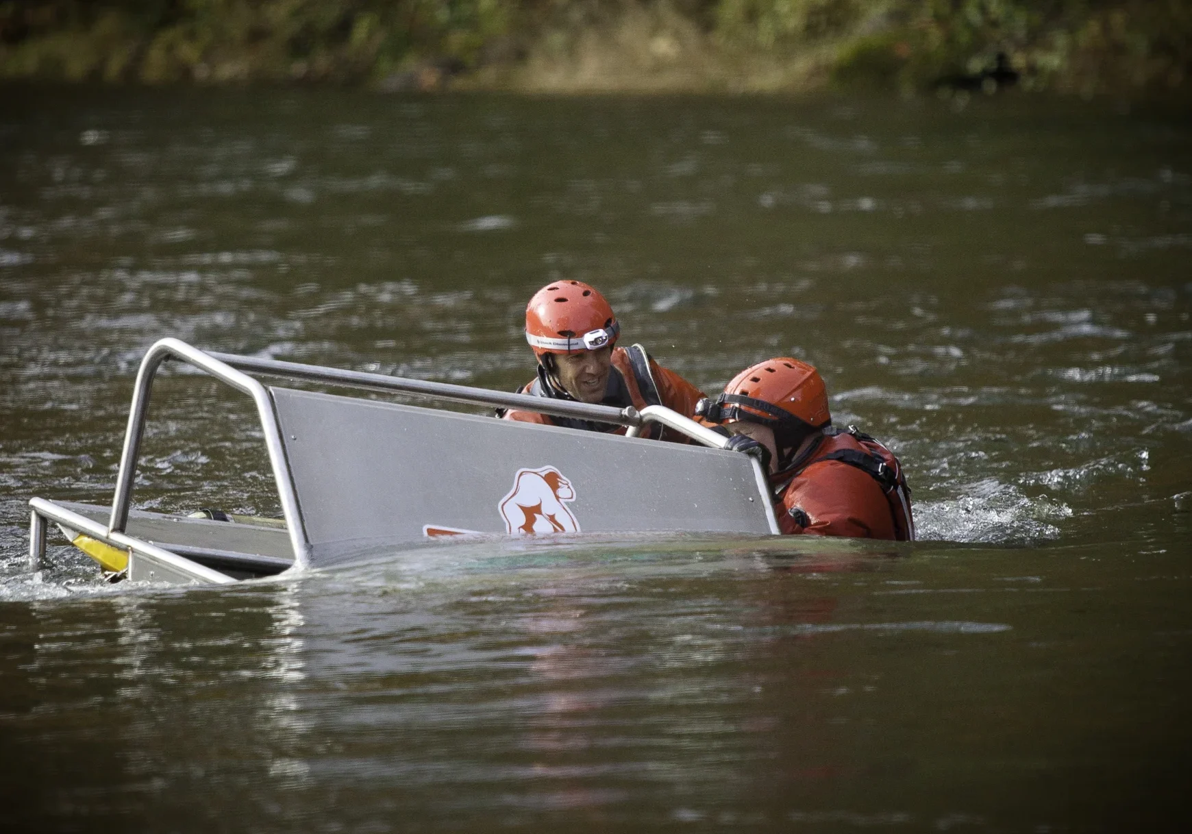 Two people in a boat on the water.